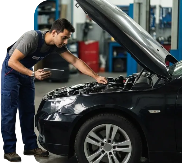Car Tool India technician diagnosing a car engine with a diagnostic tablet in a workshop